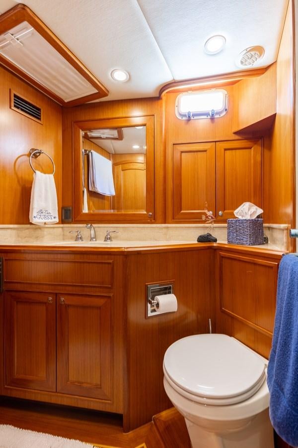 a bathroom with wooden cabinets aboard SUNSHINE Yacht for Sale