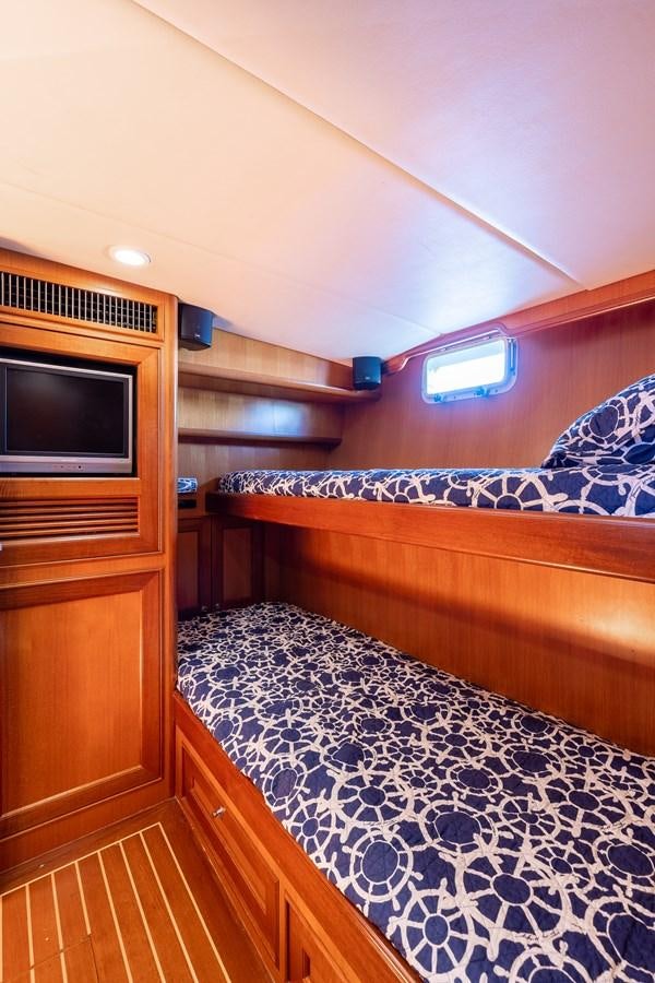 a bedroom with a bed and a tv aboard SUNSHINE Yacht for Sale
