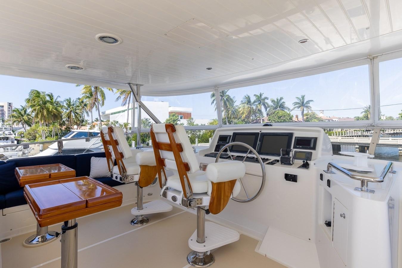 a room with tables and chairs aboard SUNSHINE Yacht for Sale