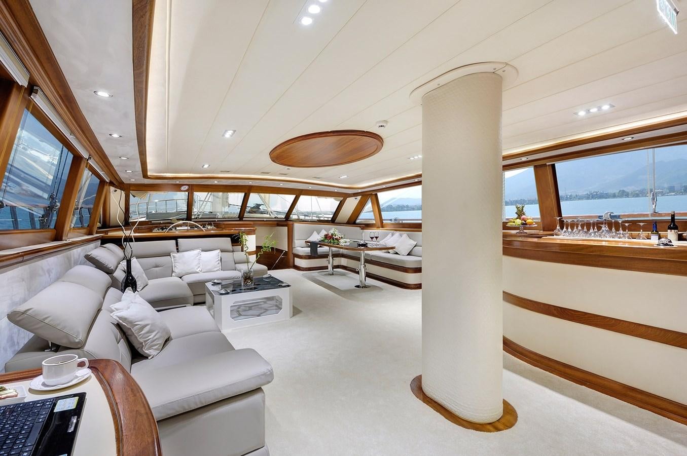 a room with a large window and a large white table with chairs aboard ALESSANDRO I Yacht for Sale