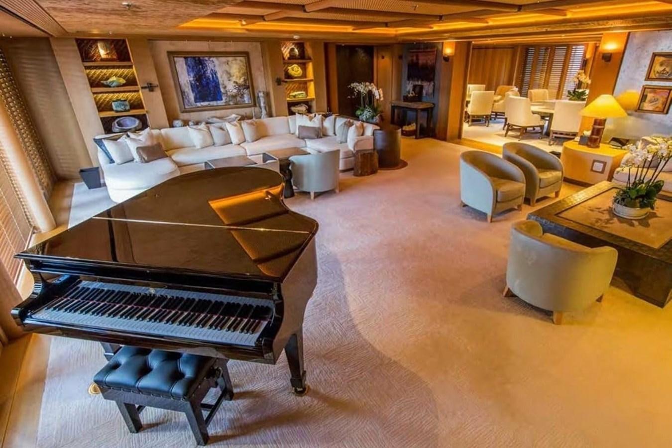 a large living room with a piano aboard PELORUS Yacht for Sale