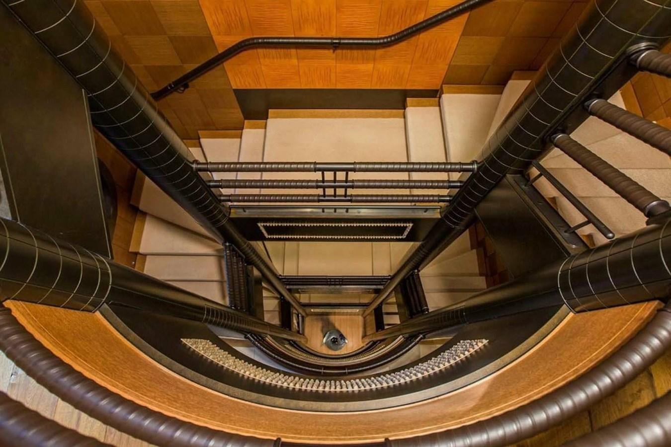 a spiral staircase with a spiral staircase aboard PELORUS Yacht for Sale