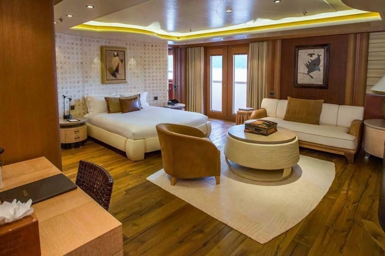 a living room with a large white couch and a table aboard PELORUS Yacht for Sale