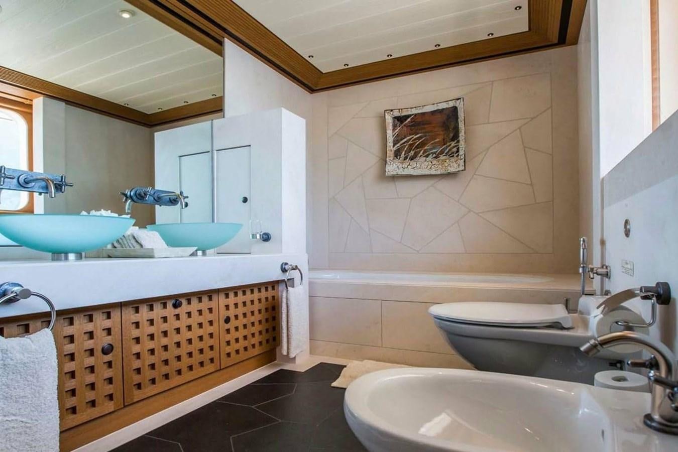 a bathroom with a tub sink and a toilet aboard PELORUS Yacht for Sale