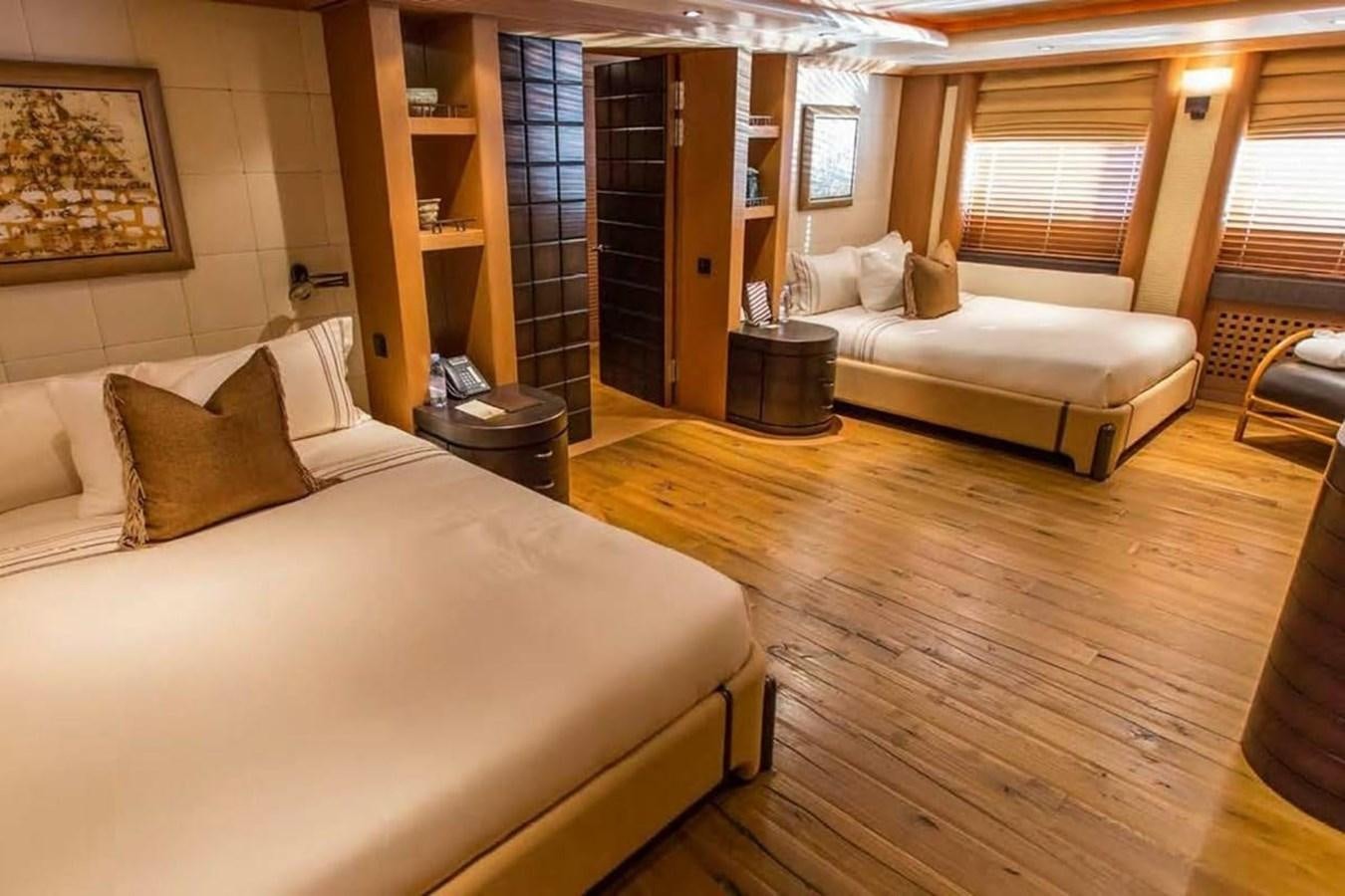 a room with a bed and a couch aboard PELORUS Yacht for Sale