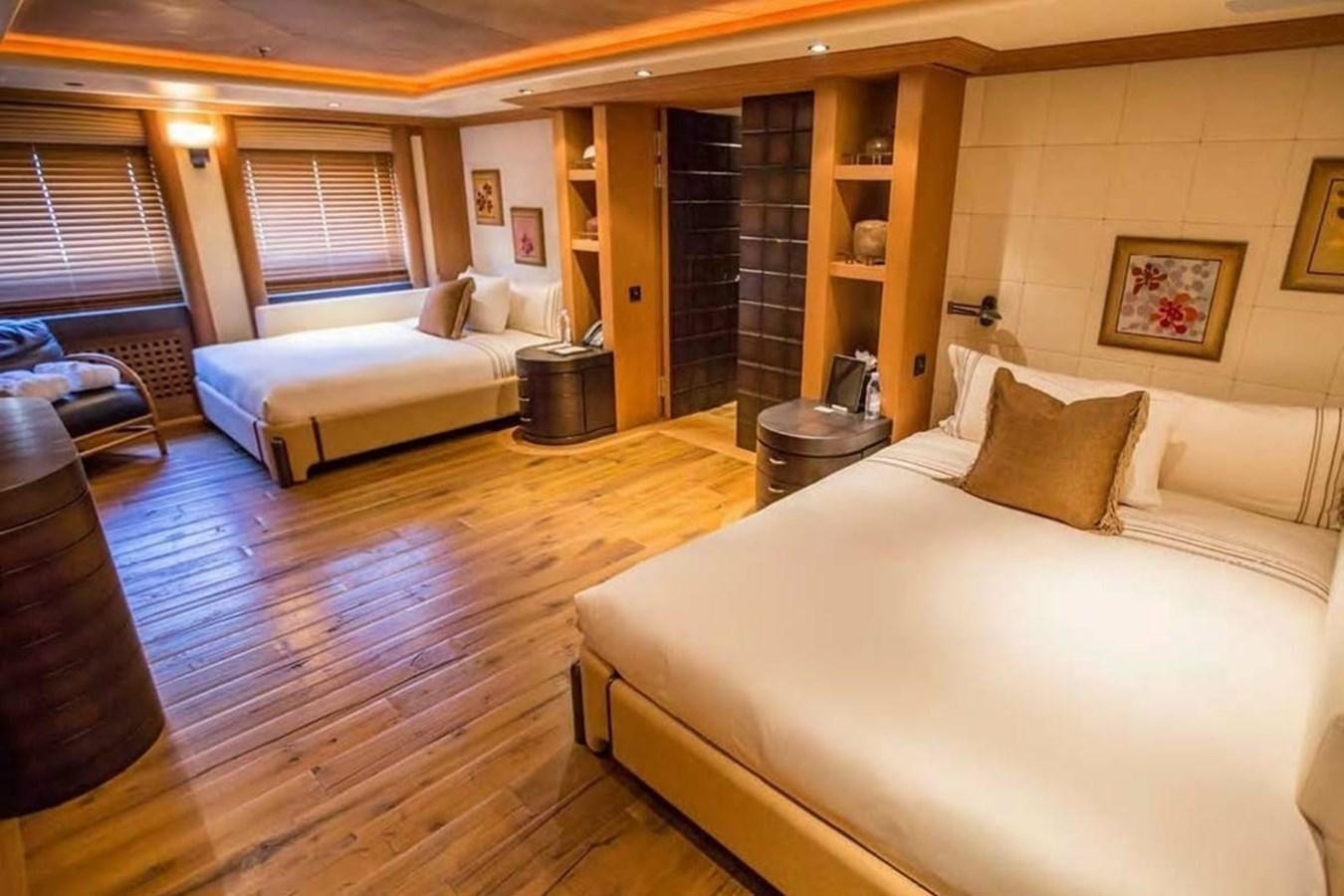 a room with a bed and a couch aboard PELORUS Yacht for Sale