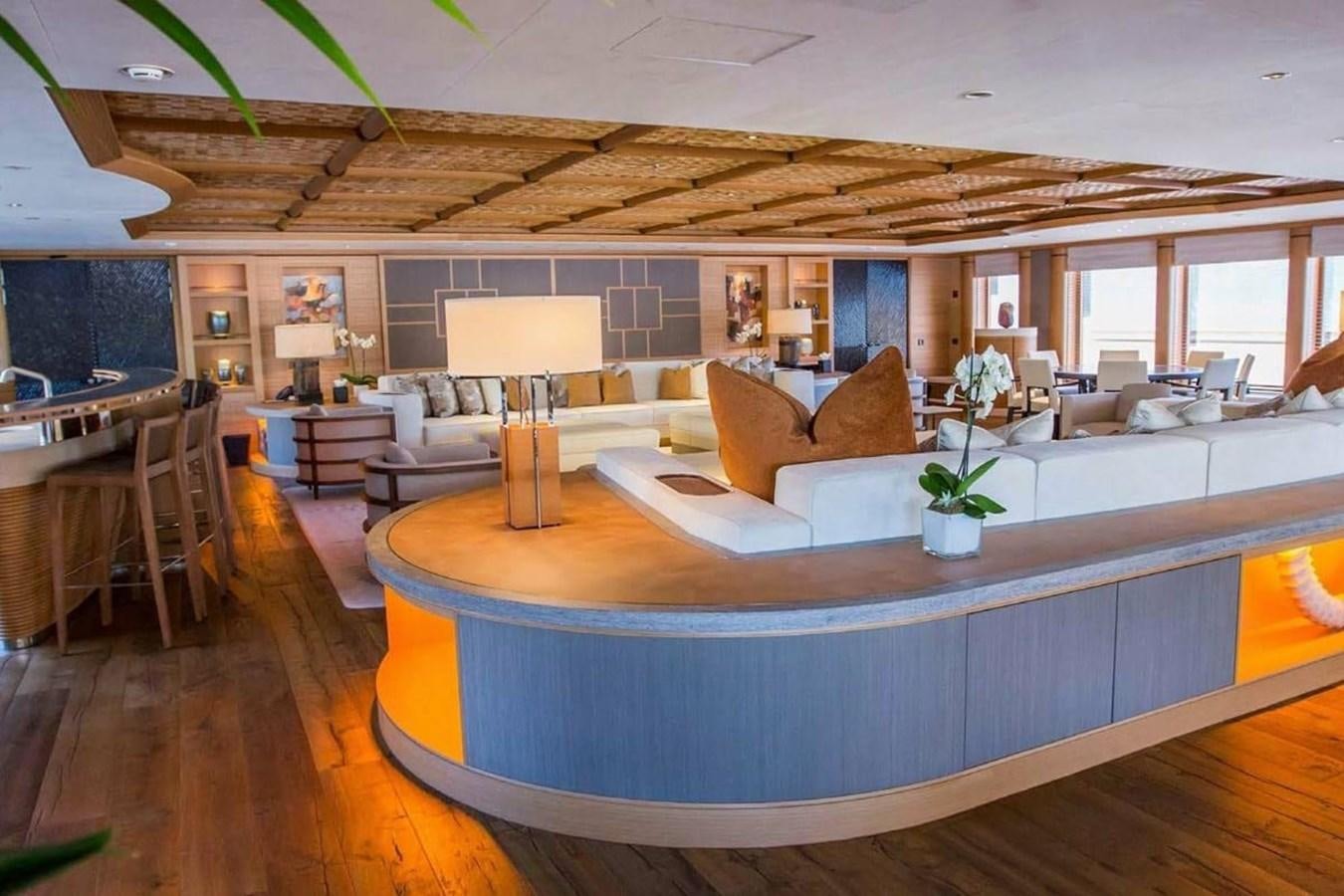a large living room with a large wood floor aboard PELORUS Yacht for Sale