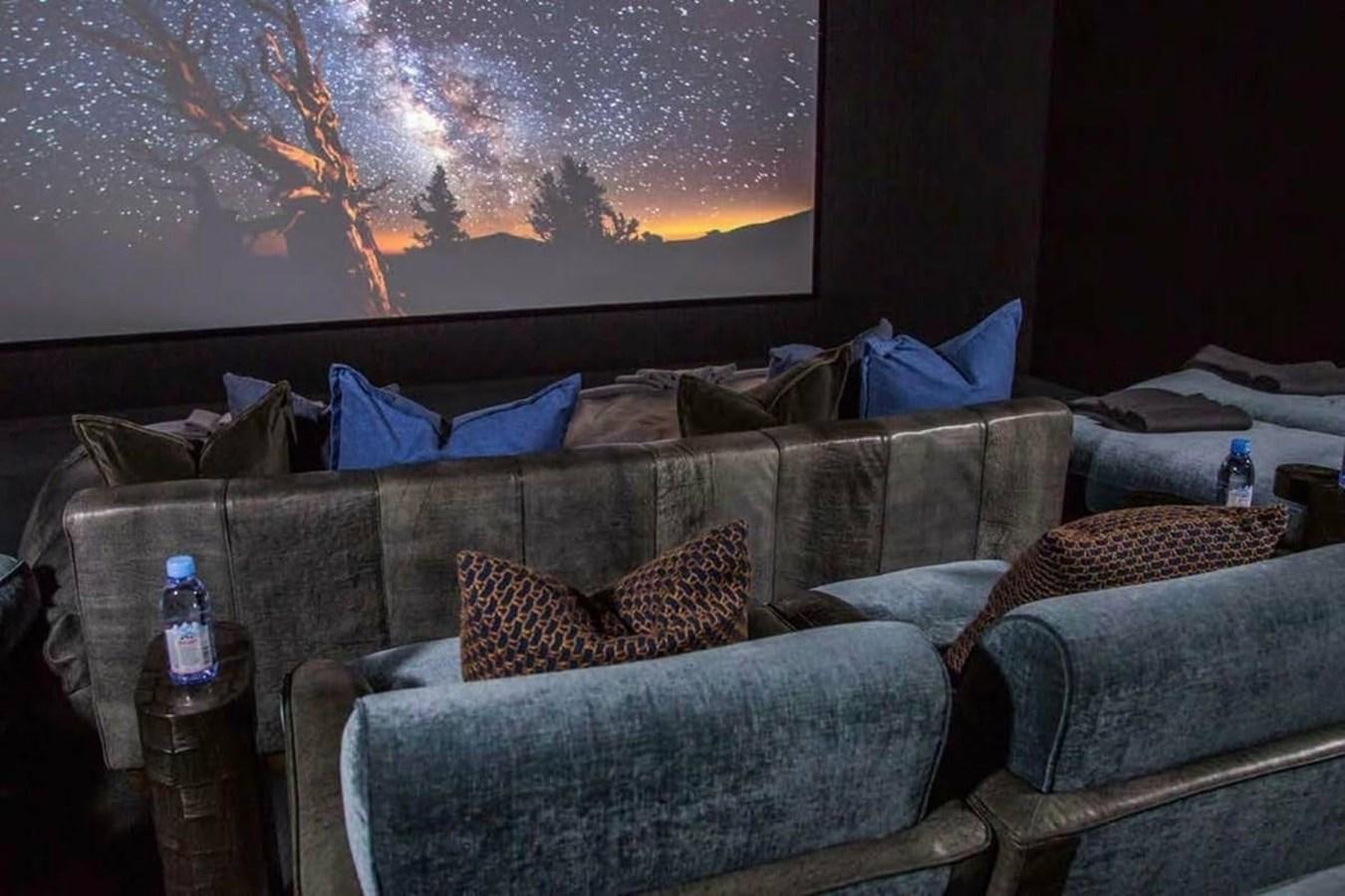 a couch with a fire in the background aboard PELORUS Yacht for Sale