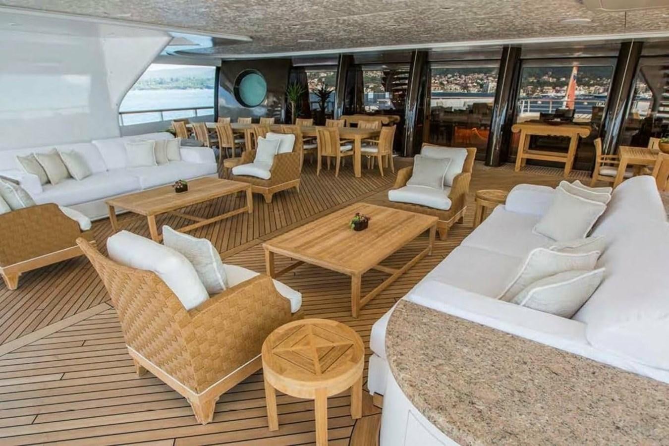 a room with couches and chairs aboard PELORUS Yacht for Sale