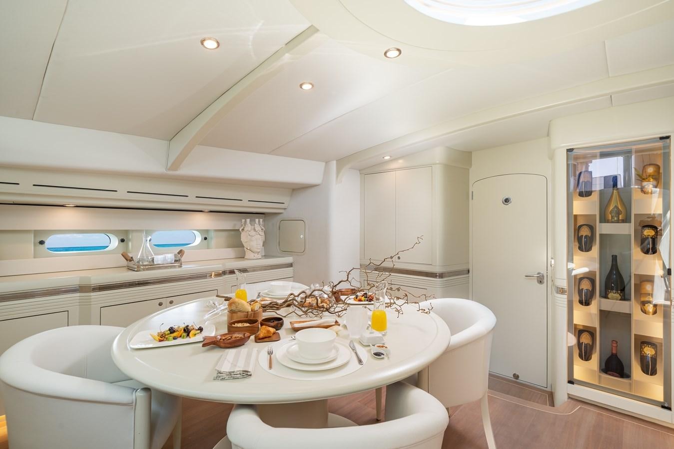 a kitchen with a table and chairs aboard ASHLEYROSE110 Yacht for Sale