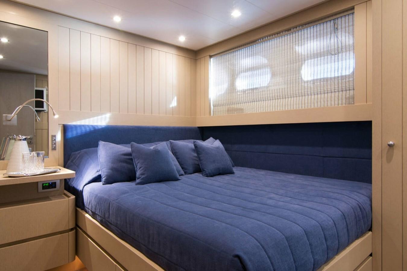 a bed with blue sheets aboard REGINA K Yacht for Sale