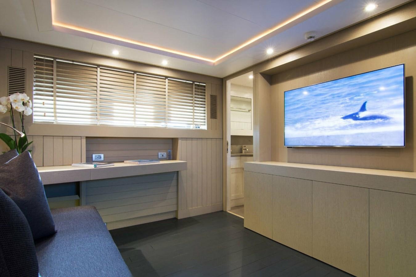 a room with a tv and a couch aboard REGINA K Yacht for Sale