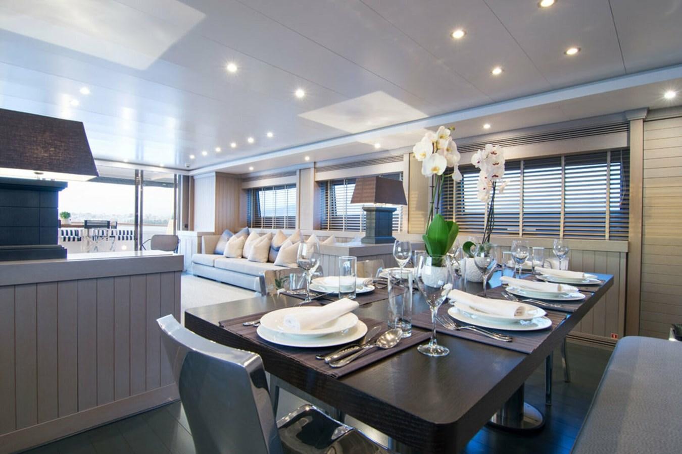 a dining room with a table set aboard REGINA K Yacht for Sale