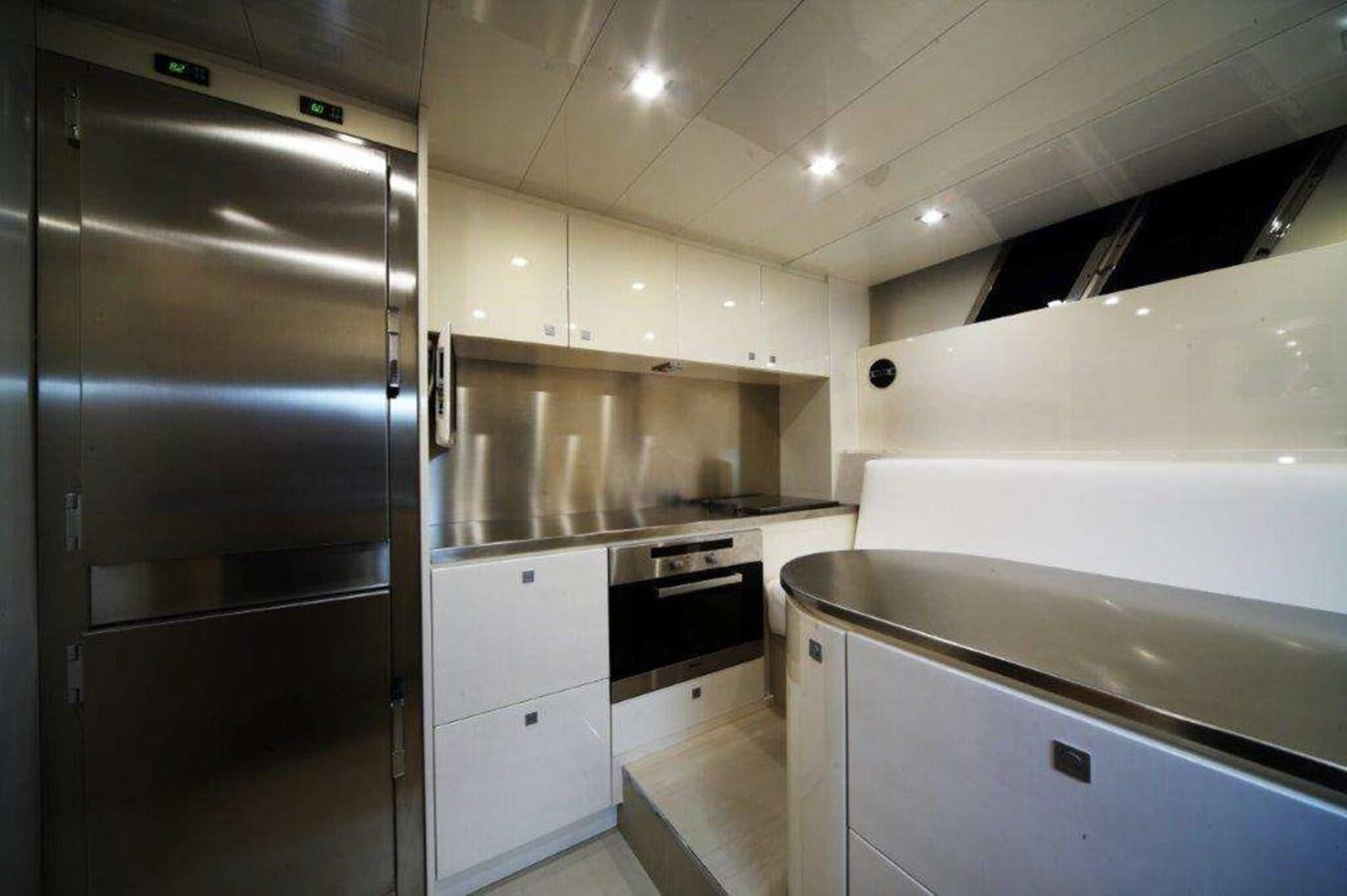 a kitchen with stainless steel appliances aboard OTAM 80 Yacht for Sale