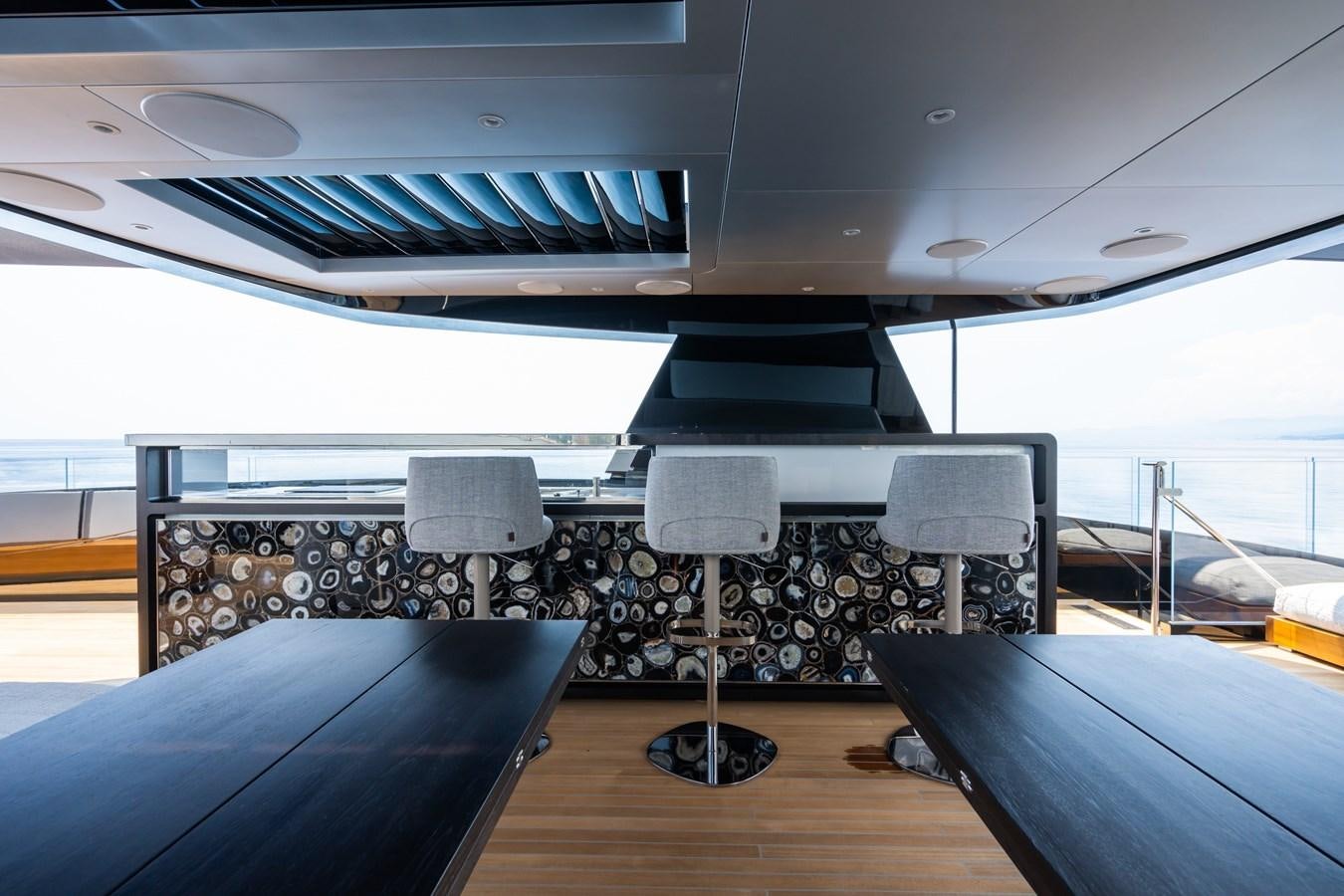 a table with chairs on it aboard JIMMY Yacht for Sale
