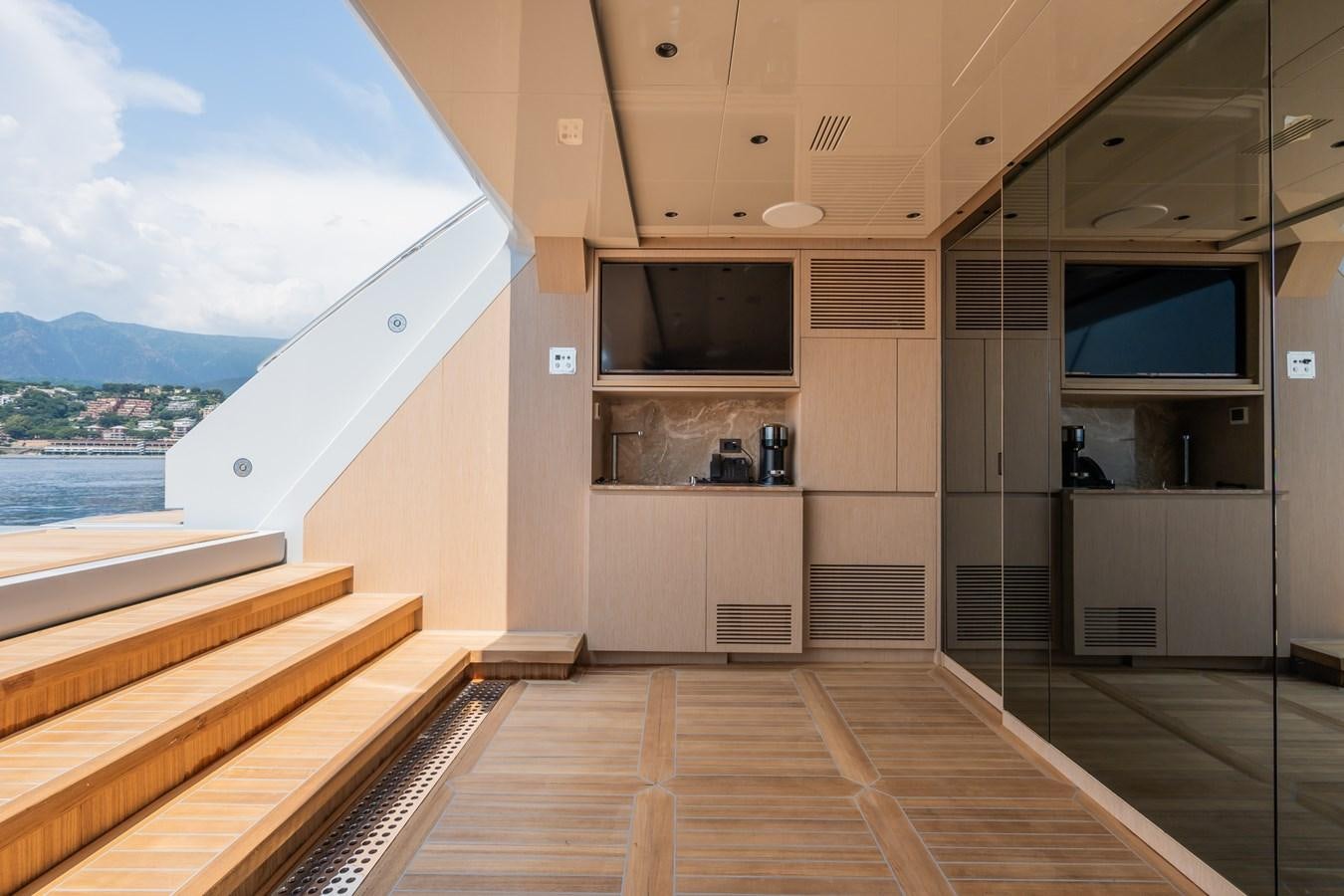 a room with a wood deck and a tv on the wall aboard JIMMY Yacht for Sale