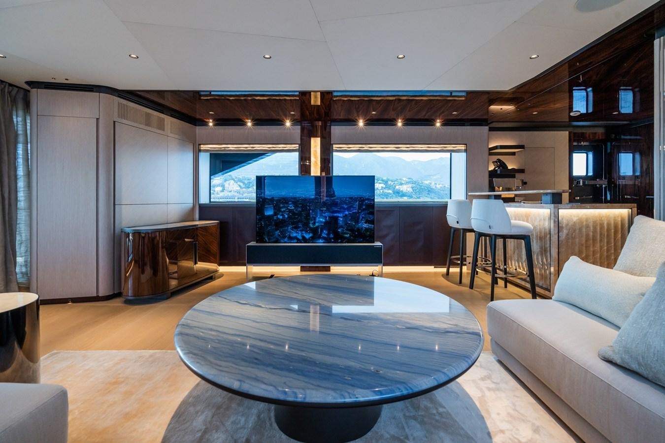 a living room with a large table and a large tv aboard JIMMY Yacht for Sale