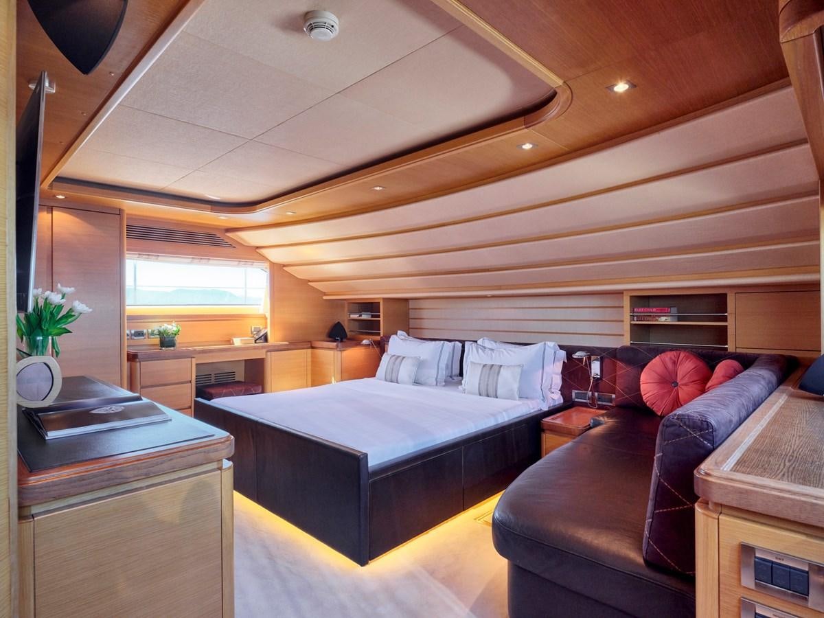 a bedroom with a bed and a couch aboard SEVEN S Yacht for Sale