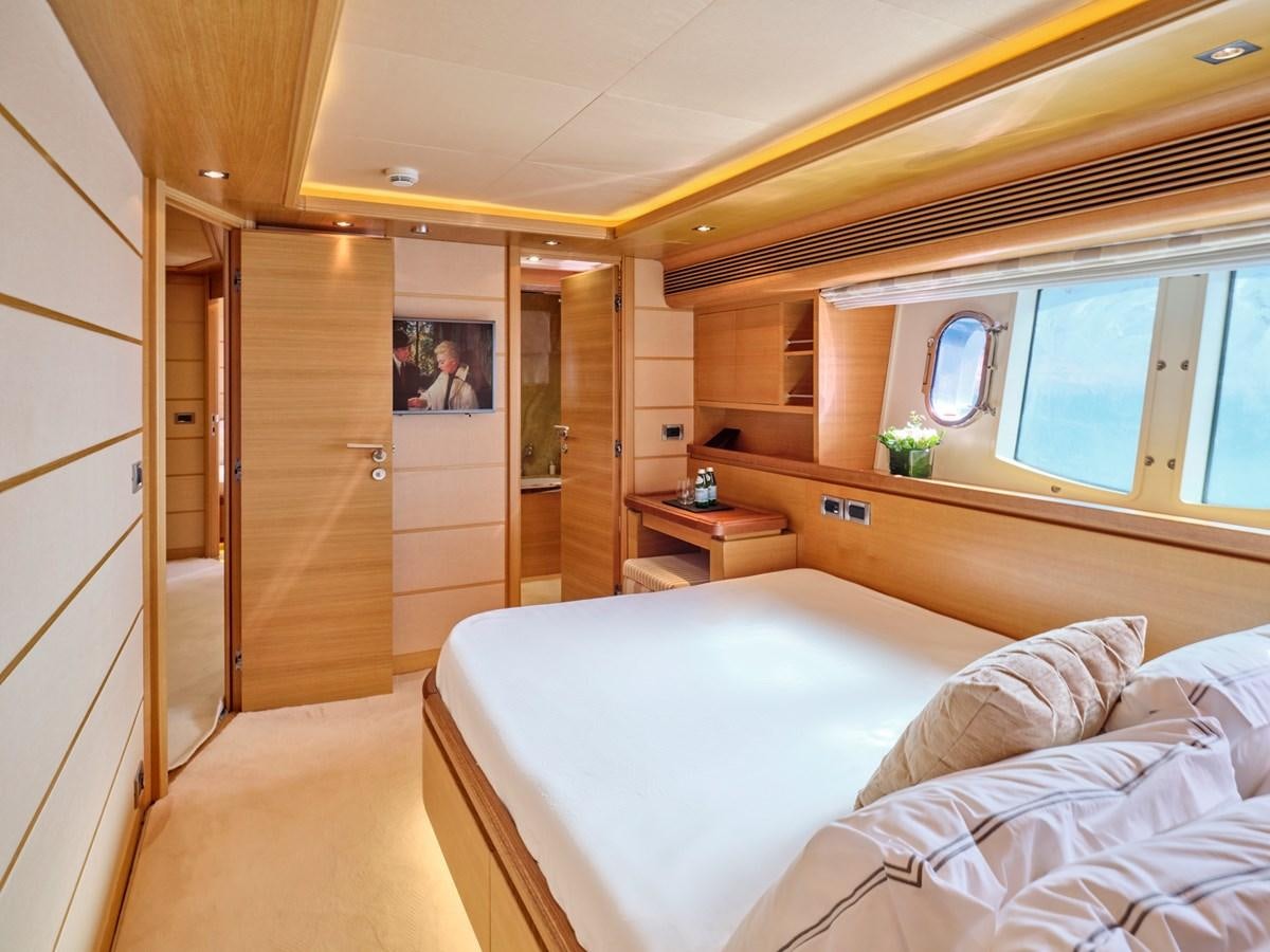 a bedroom with a bed and a closet aboard SEVEN S Yacht for Sale