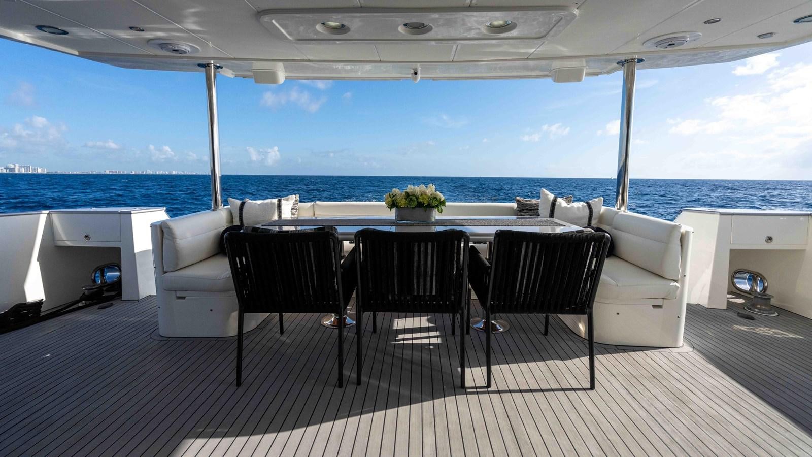 a table and chairs on a deck aboard NEVER SETTLE Yacht for Sale