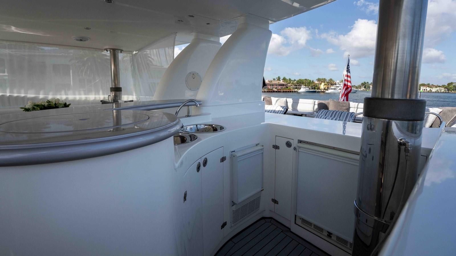 a boat with a flag on the deck aboard NEVER SETTLE Yacht for Sale