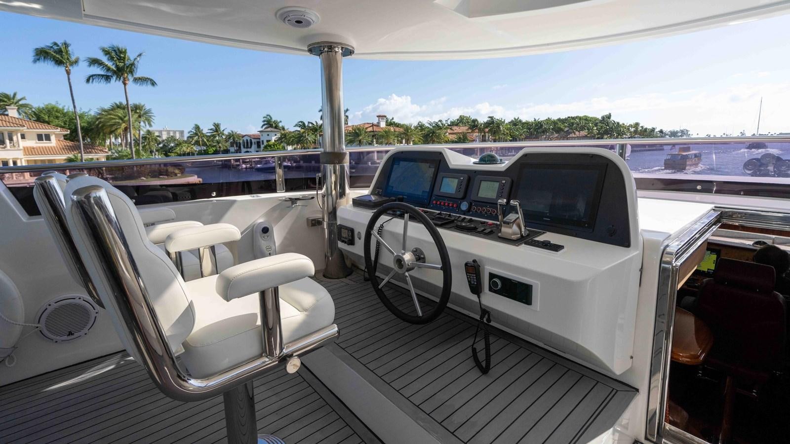 a car with a large wheel aboard NEVER SETTLE Yacht for Sale