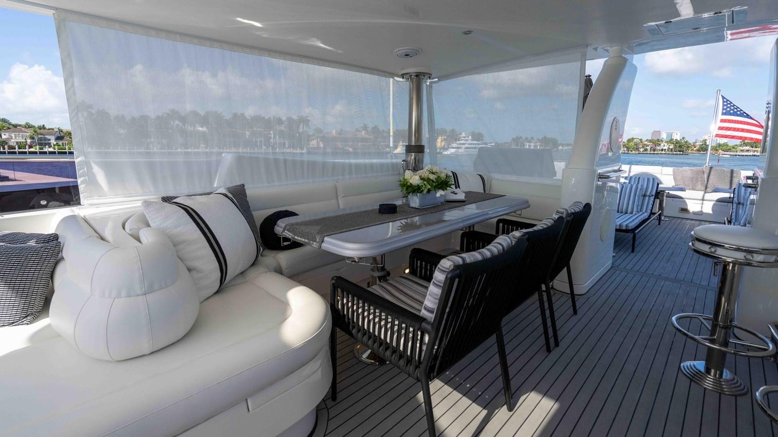 a room with a table chairs and a flag aboard NEVER SETTLE Yacht for Sale