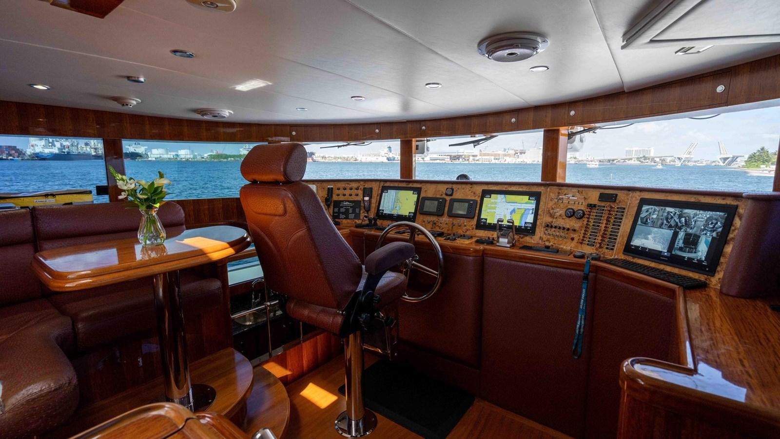 a room with a table and chairs aboard NEVER SETTLE Yacht for Sale