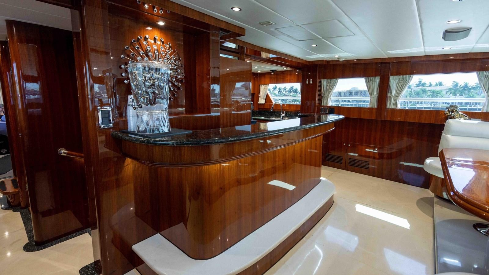 a large bar with a table aboard NEVER SETTLE Yacht for Sale