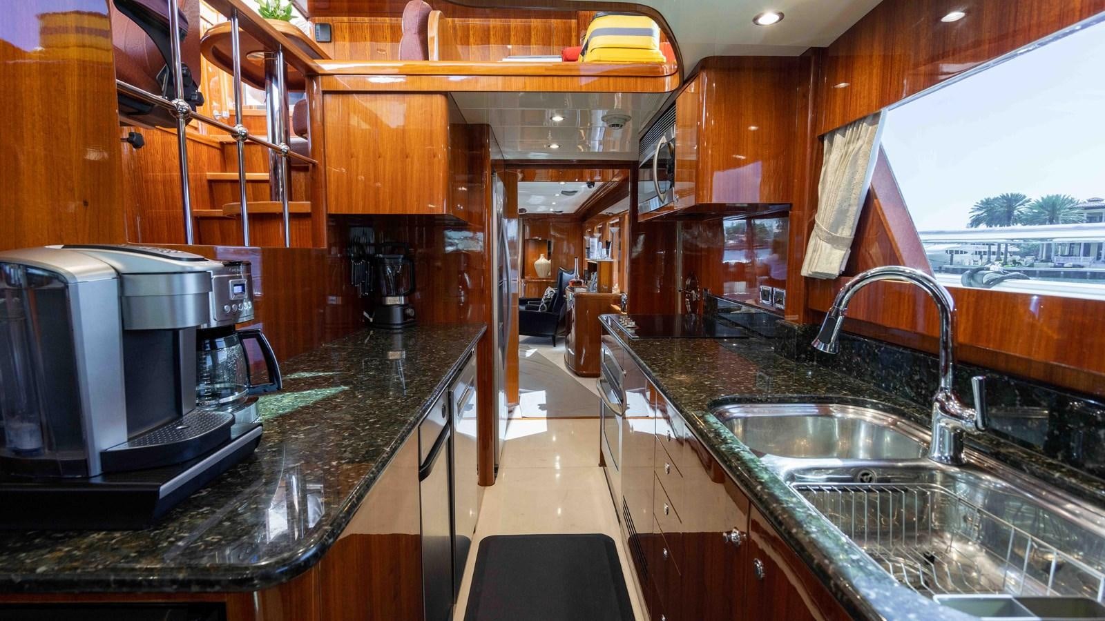 a kitchen with a sink and a microwave aboard NEVER SETTLE Yacht for Sale
