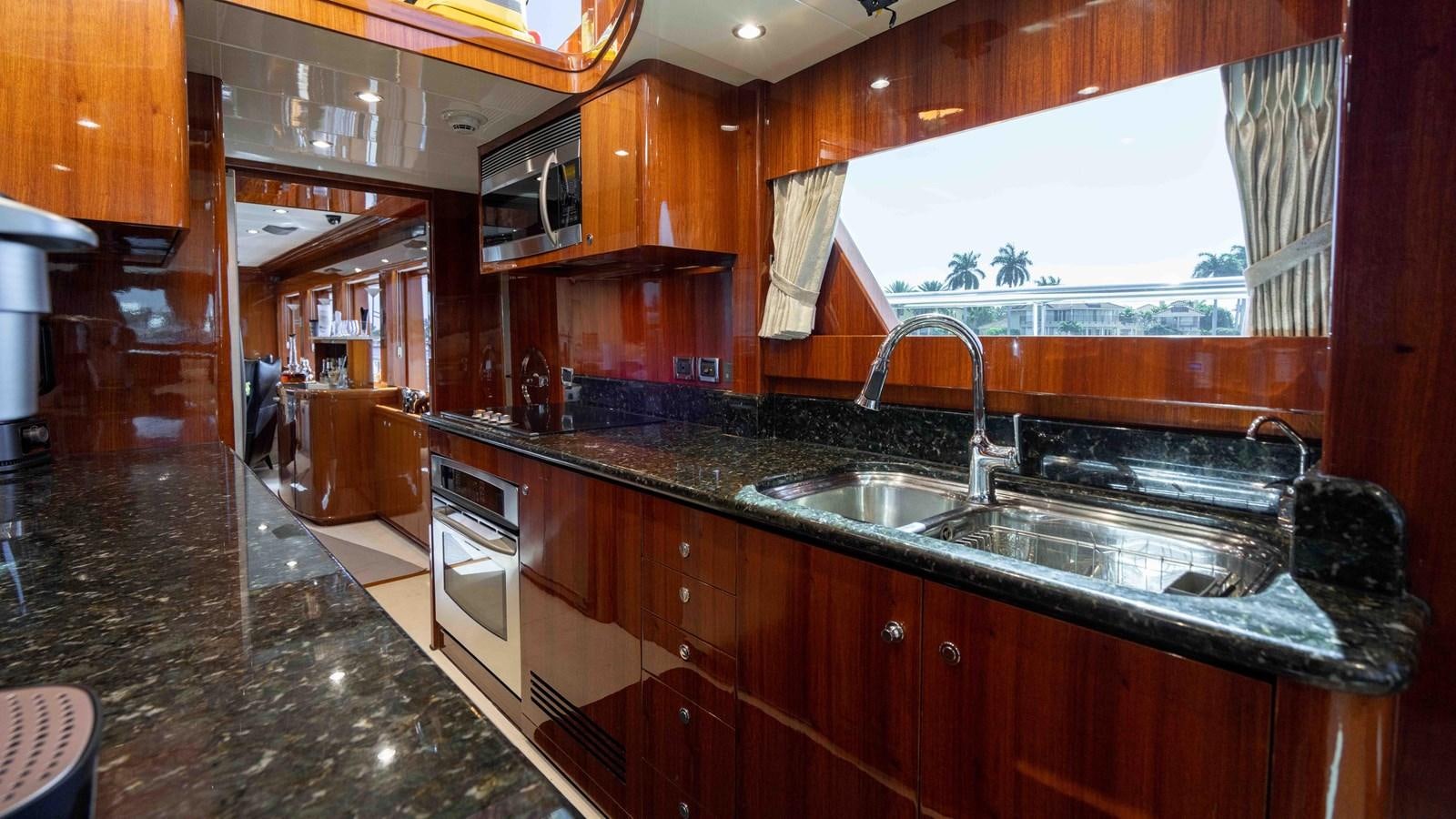 a kitchen with wooden cabinets aboard NEVER SETTLE Yacht for Sale