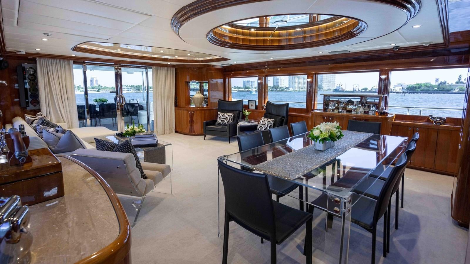 a large room with a table and chairs aboard NEVER SETTLE Yacht for Sale