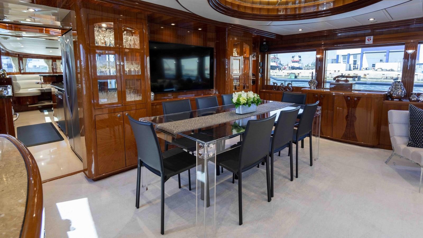 a large room with a table and chairs aboard NEVER SETTLE Yacht for Sale