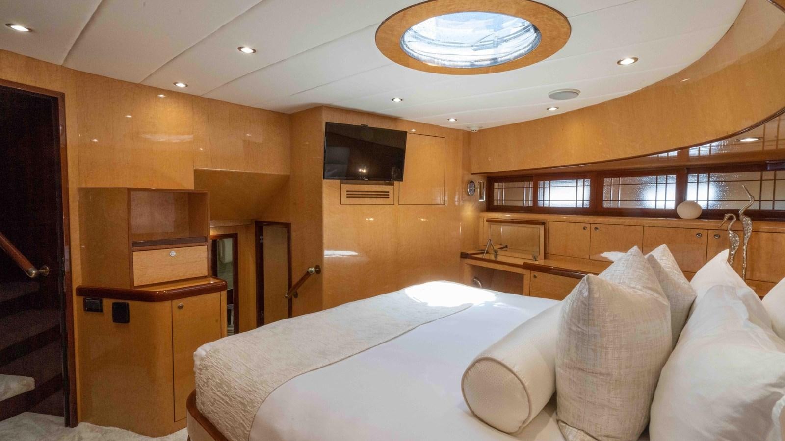 a room with a bed and a desk aboard NEVER SETTLE Yacht for Sale