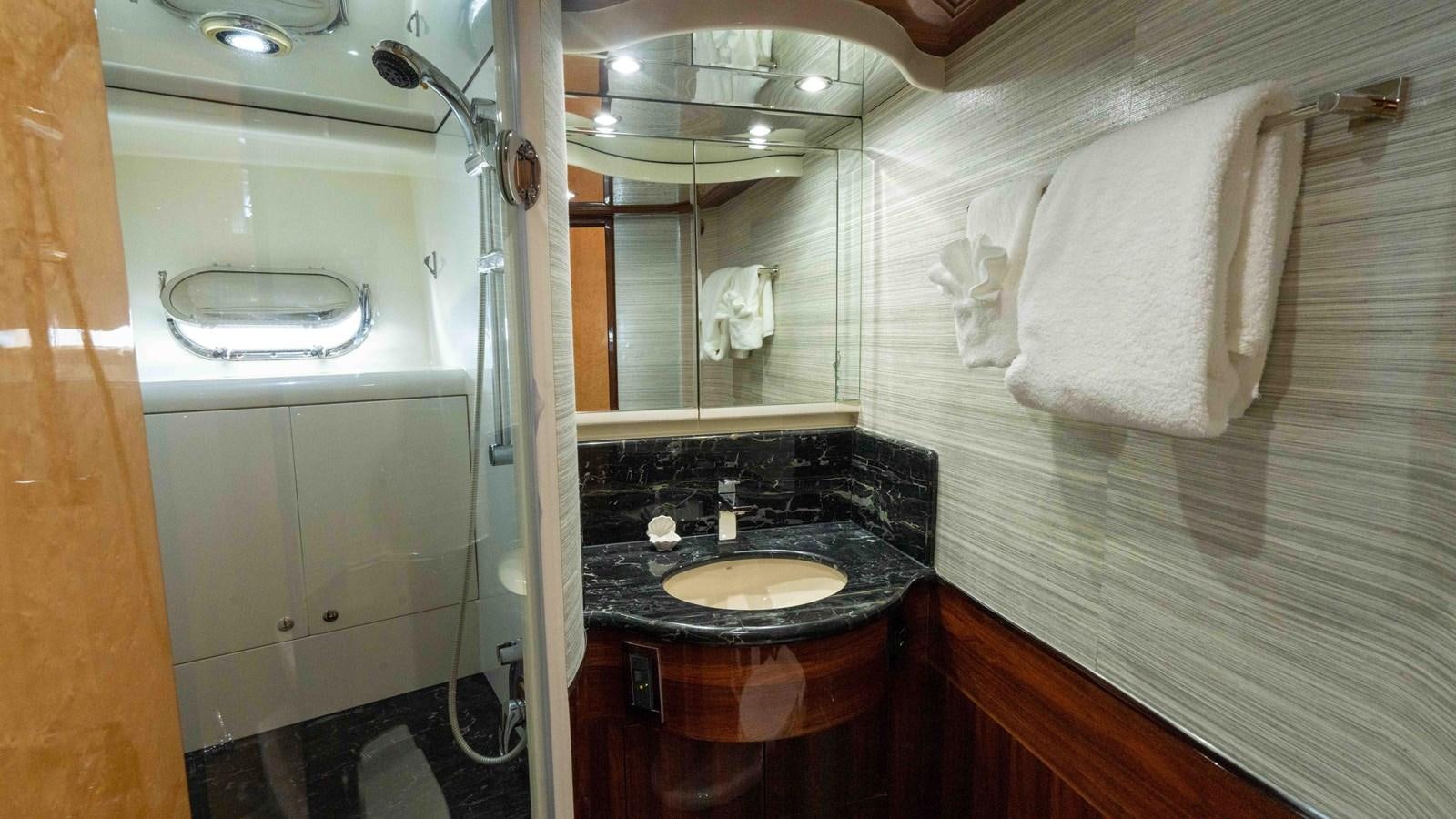 a bathroom with a sink and a mirror aboard NEVER SETTLE Yacht for Sale