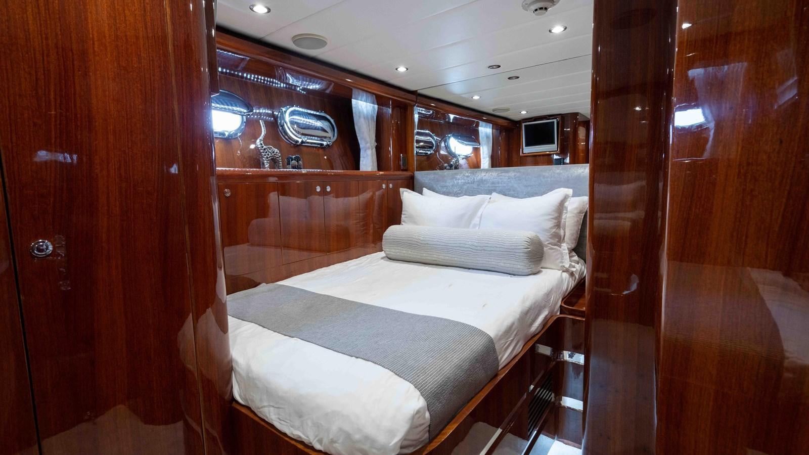 a room with a bed and a wood door aboard NEVER SETTLE Yacht for Sale