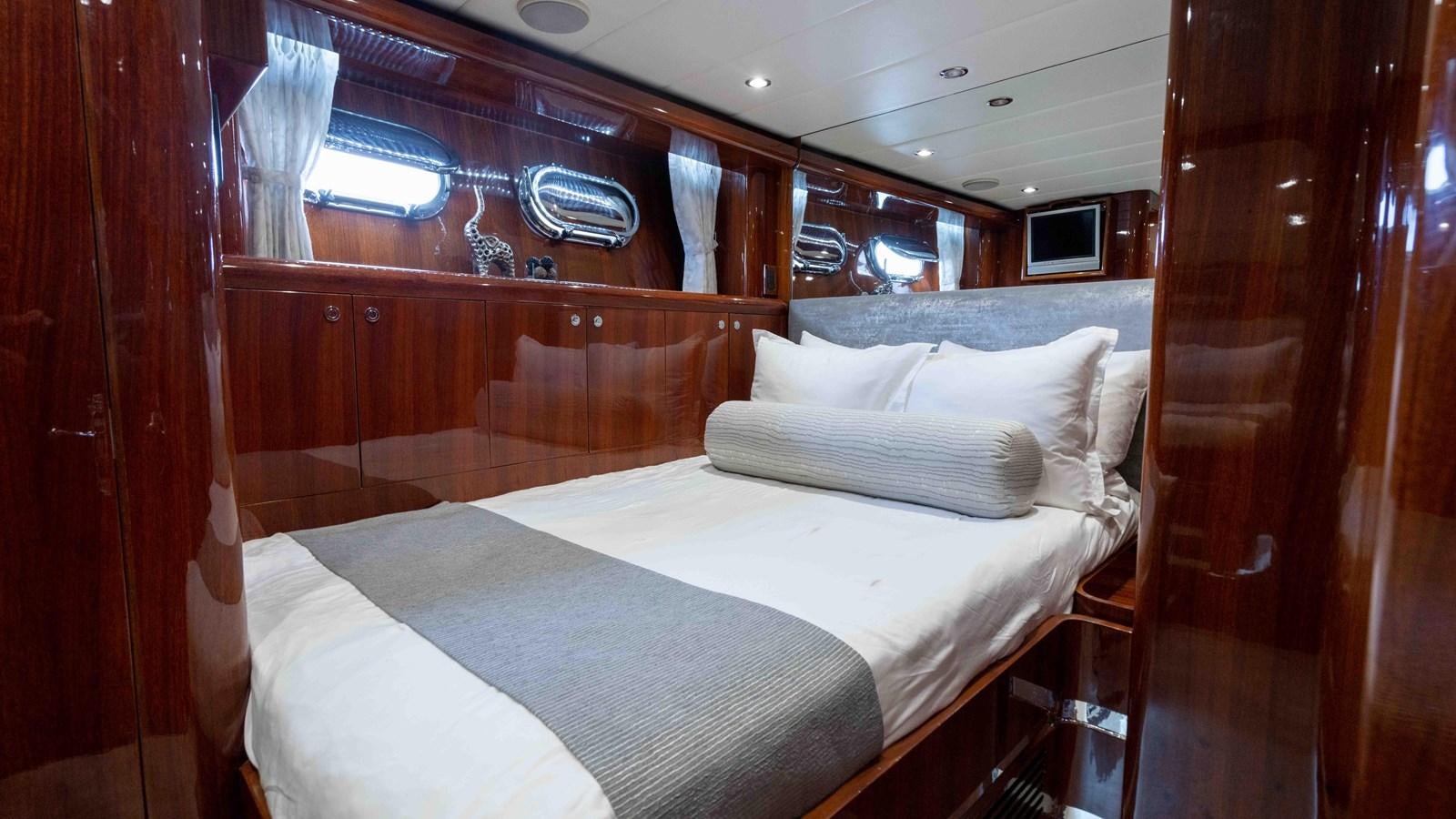 a room with a bed and a window aboard NEVER SETTLE Yacht for Sale