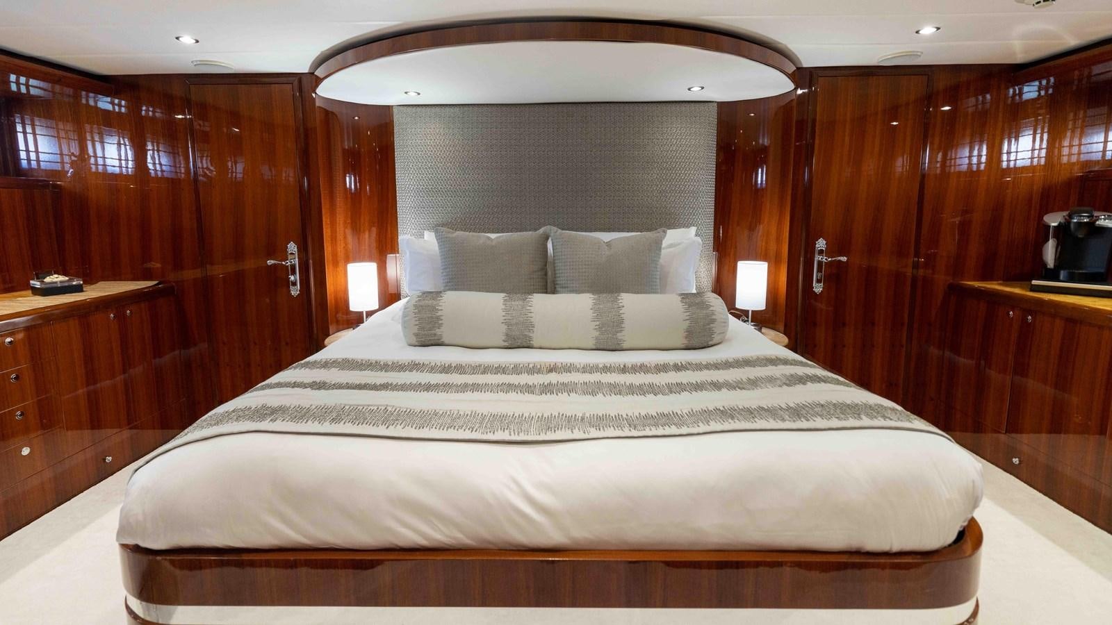 a bed with a mirror above it aboard NEVER SETTLE Yacht for Sale