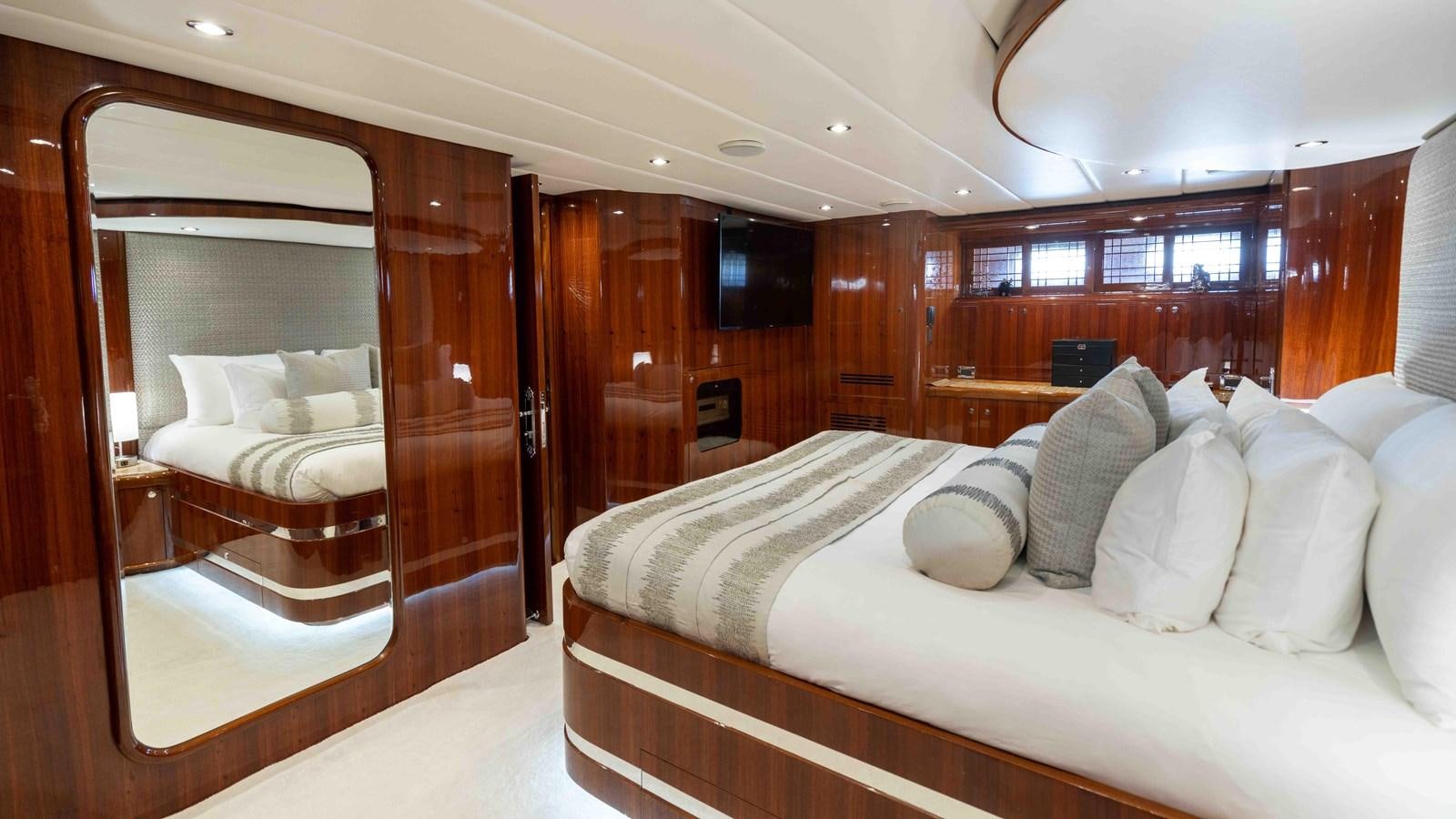 a room with a bed and a mirror aboard NEVER SETTLE Yacht for Sale