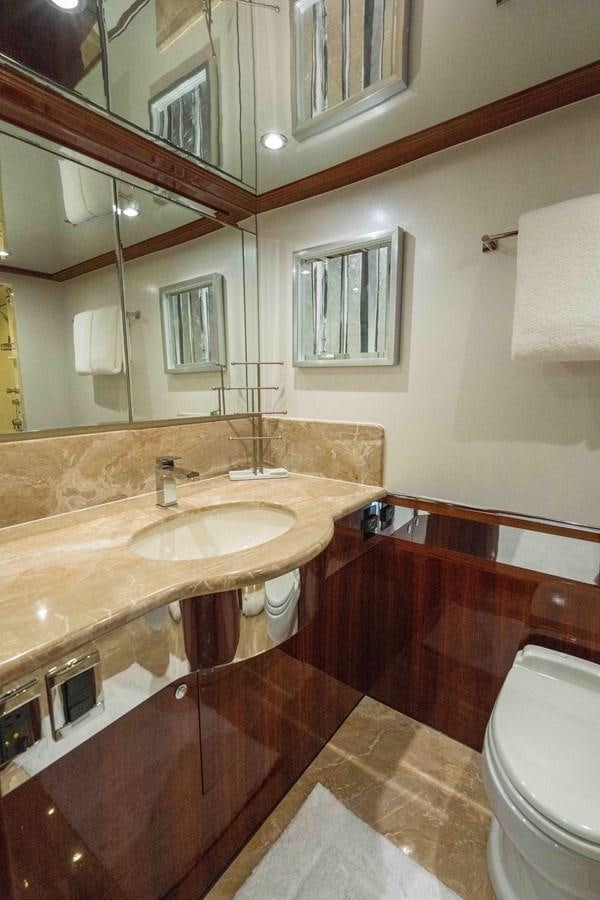 a bathroom with a sink and a mirror aboard NEVER SETTLE Yacht for Sale