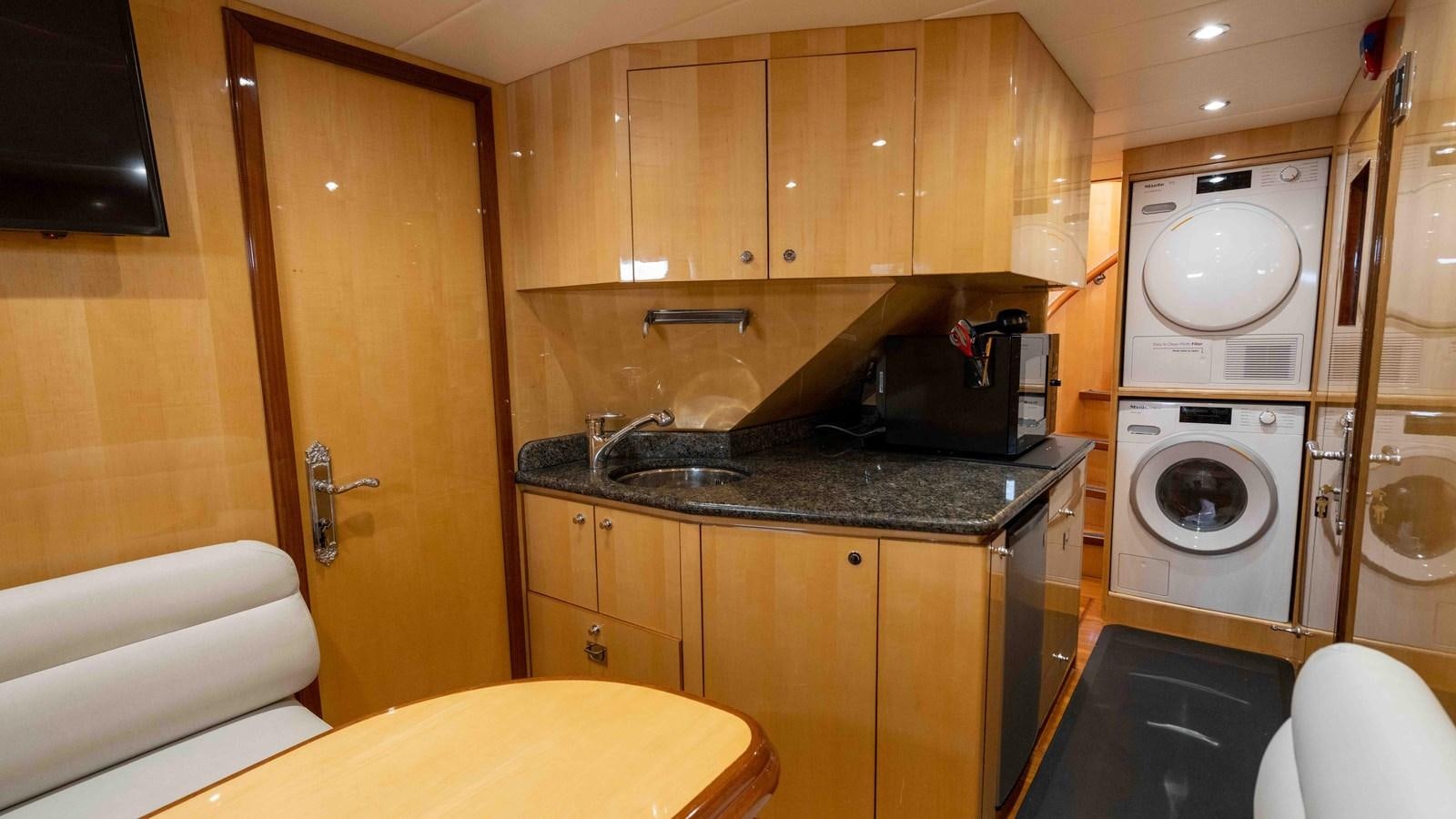 a kitchen with wooden cabinets aboard NEVER SETTLE Yacht for Sale