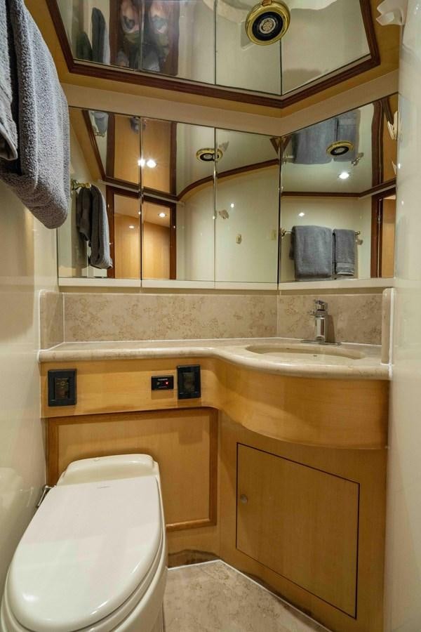 a bathroom with a toilet and sink aboard NEVER SETTLE Yacht for Sale