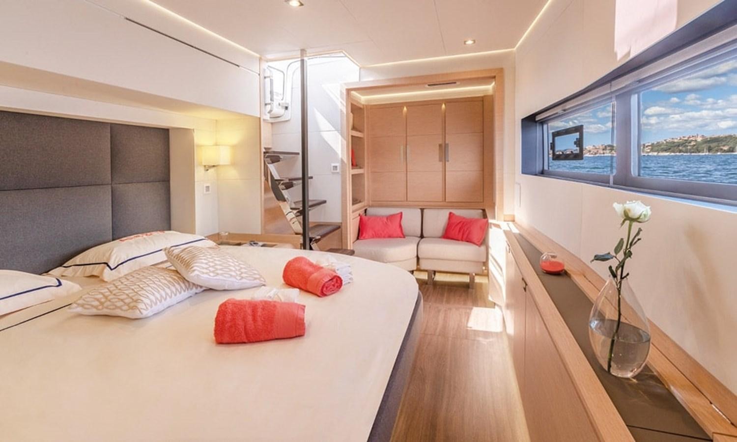 a room with a bed and a table aboard FOUNTAINE PAJOT ALEGRIA 67 Yacht for Sale
