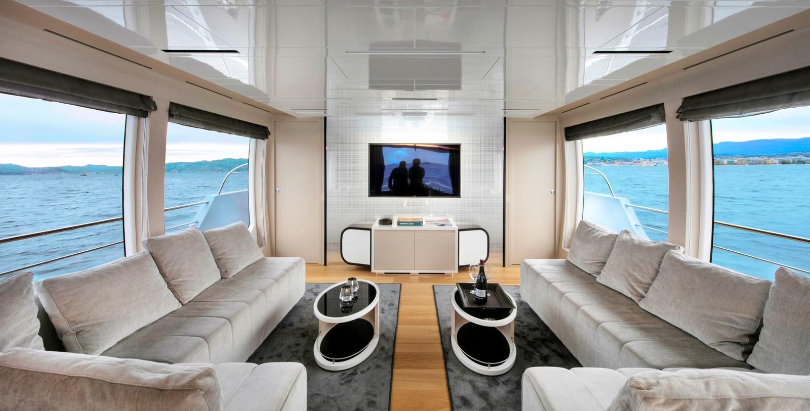 a living room with a large flat screen television and a large window aboard 2025 CANADOS 808’ MAXIMUS Yacht for Sale