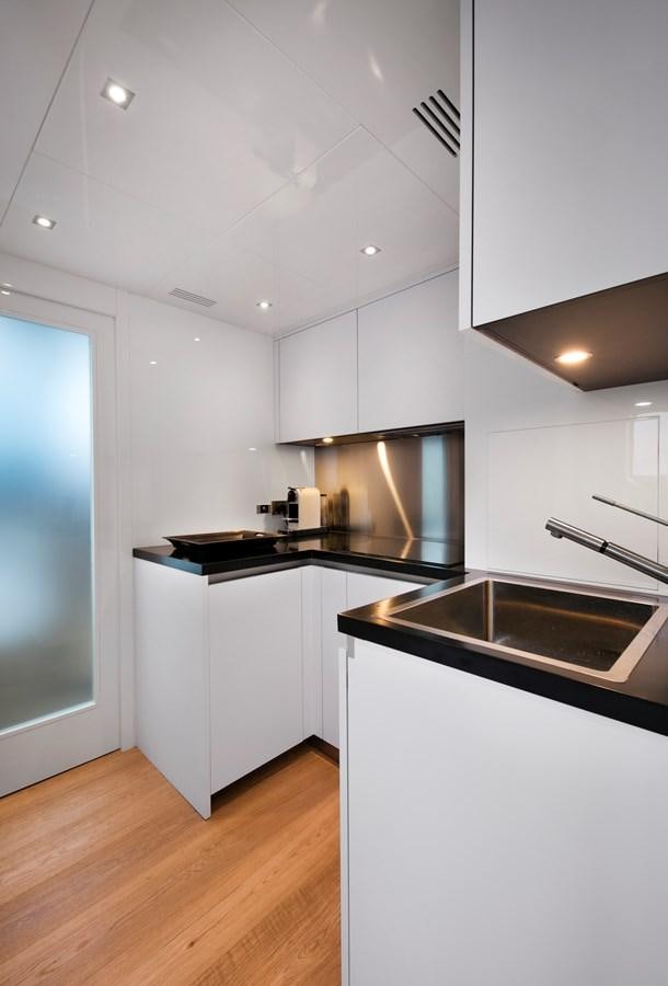 a kitchen with white cabinets aboard 2025 CANADOS 808’ MAXIMUS Yacht for Sale