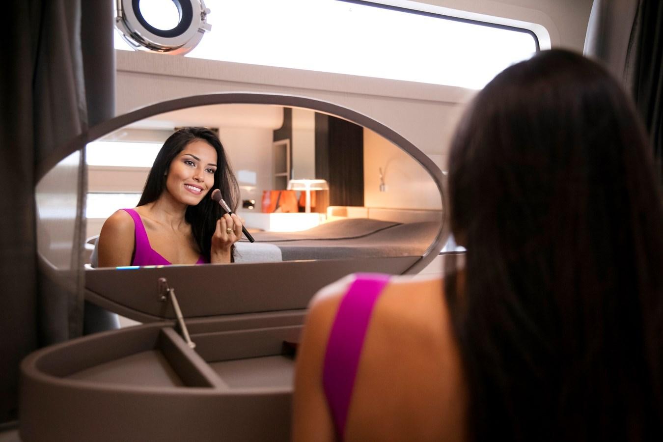 a woman looking at a mirror aboard 2025 CANADOS 808’ MAXIMUS Yacht for Sale