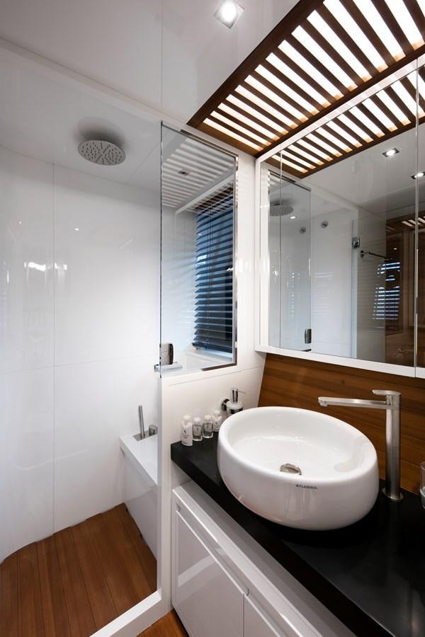 a bathroom with a sink and a large mirror aboard 2025 CANADOS 808’ MAXIMUS Yacht for Sale