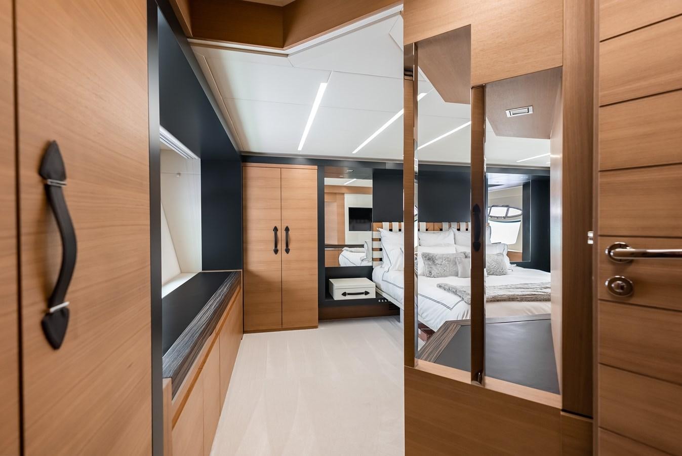 a room with a bed and a closet aboard MORNINGSTAR Yacht for Sale