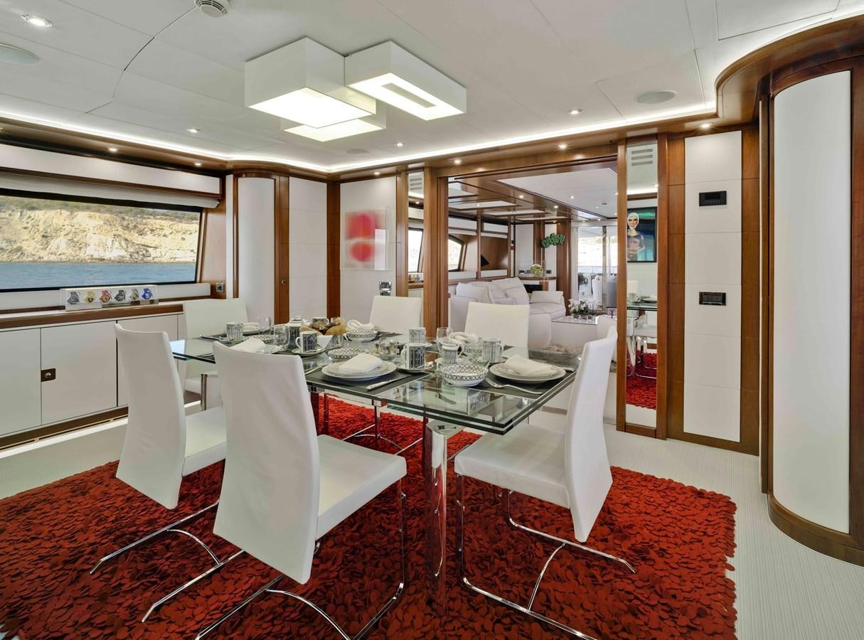 a dining room with white chairs aboard BUNKER Yacht for Sale