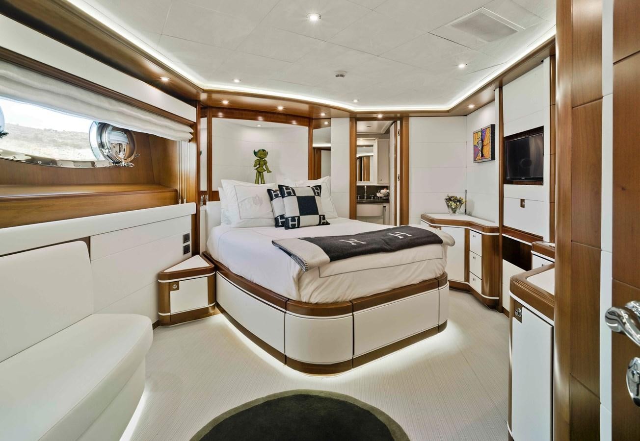 a bedroom with a bed and a television aboard BUNKER Yacht for Sale